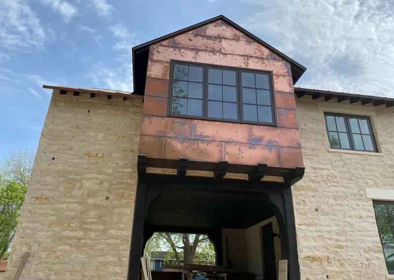 Copper metal panel facade on a stone building for Skylight Installation in Pleasant Grove
