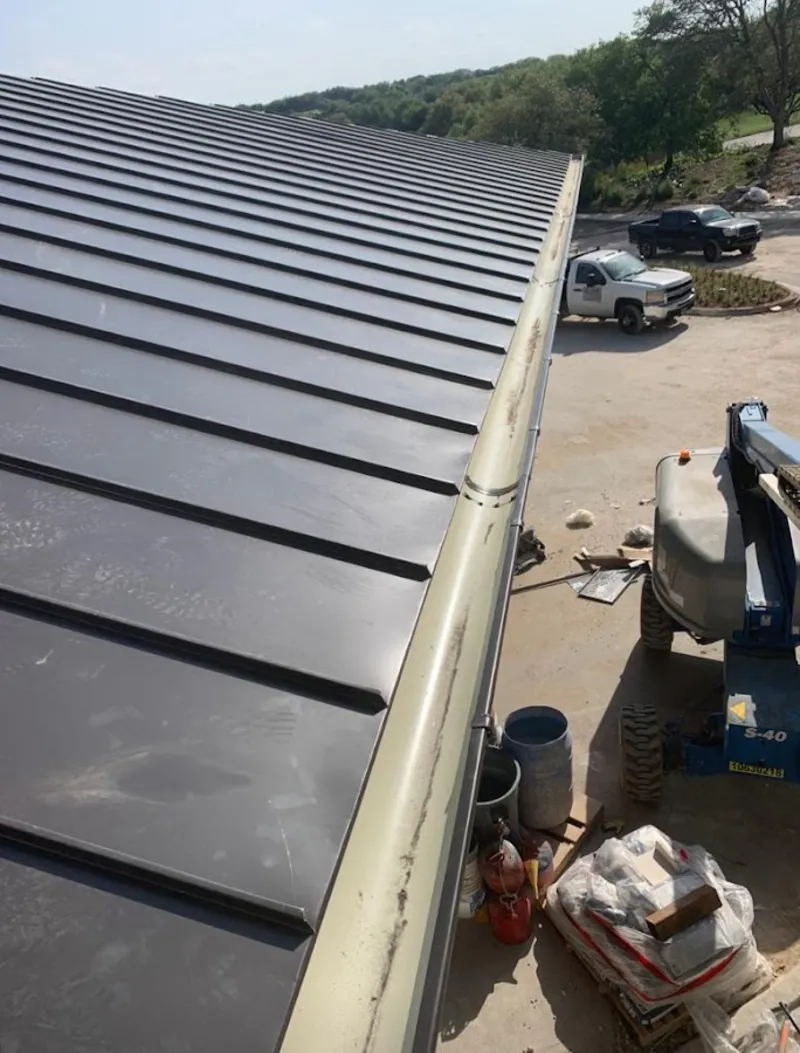 Standing seam panel and gutter detail on a metal roofing jobsite in Pleasant Grove